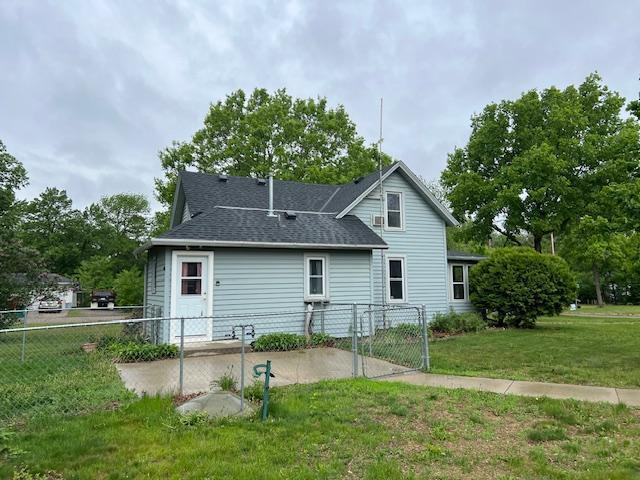 323 Weisel St, Litchfield, MN 55355 - back of property with roof with shingles and a gate