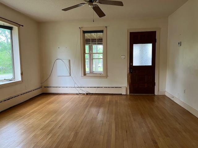 323 Weisel St, Litchfield, MN 55355 - spare room with light wood finished floors, a ceiling fan, and baseboards