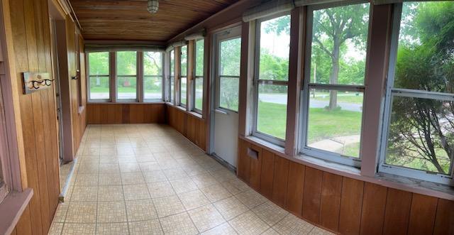 323 Weisel St, Litchfield, MN 55355 - unfurnished sunroom featuring wooden ceiling and wood walls
