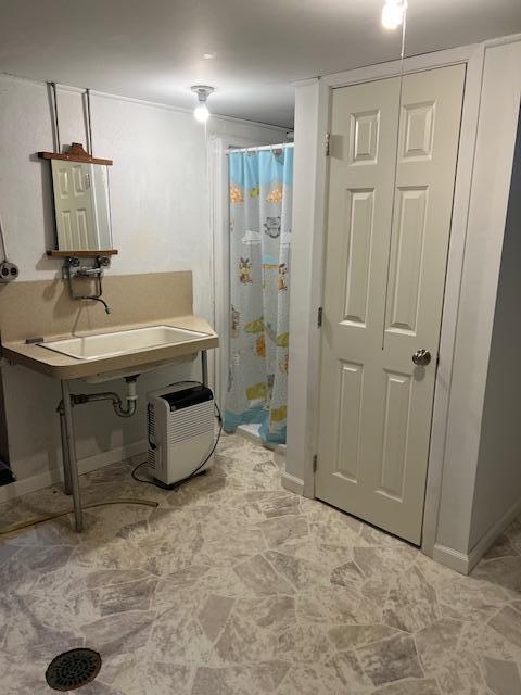 323 Weisel St, Litchfield, MN 55355 - bathroom featuring a shower with curtain and baseboards