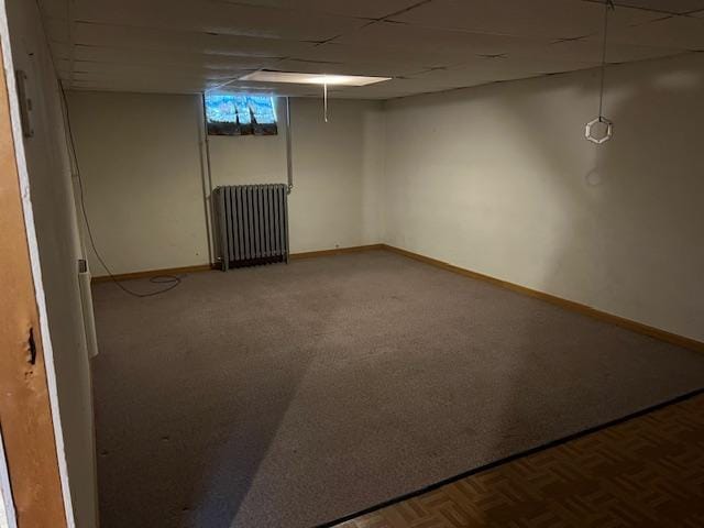 323 Weisel St, Litchfield, MN 55355 - below grade area featuring radiator heating unit, baseboards, and carpet floors