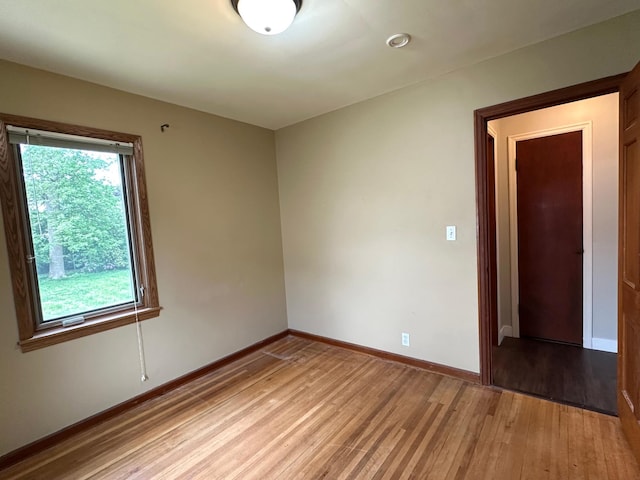 unfurnished room with light wood-style floors and baseboards