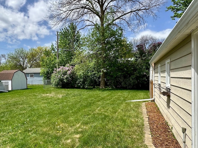 view of yard featuring a shed and an outbuilding