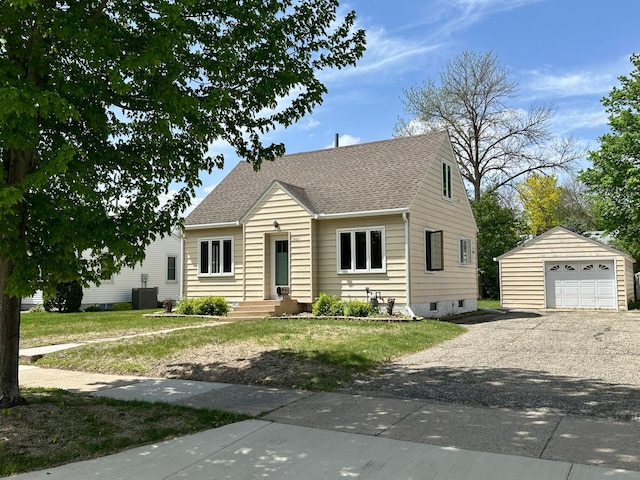 view of front of home with an outbuilding, cooling unit, roof with shingles, driveway, and a detached garage