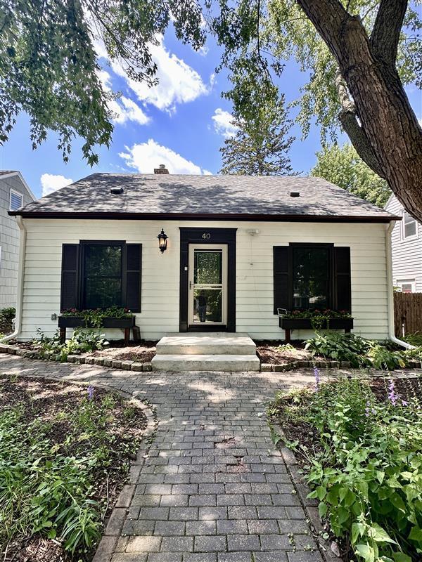 40 Penn Ave S, Minneapolis, MN 55405 - view of front of property featuring a shingled roof and a chimney