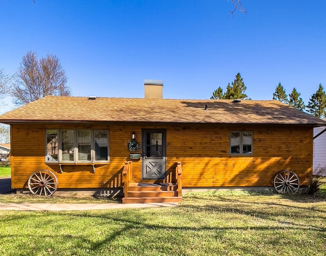 110 Hays Cir, Silver Bay, MN 55614 - view of front of home featuring a front yard, a chimney, and a shingled roof