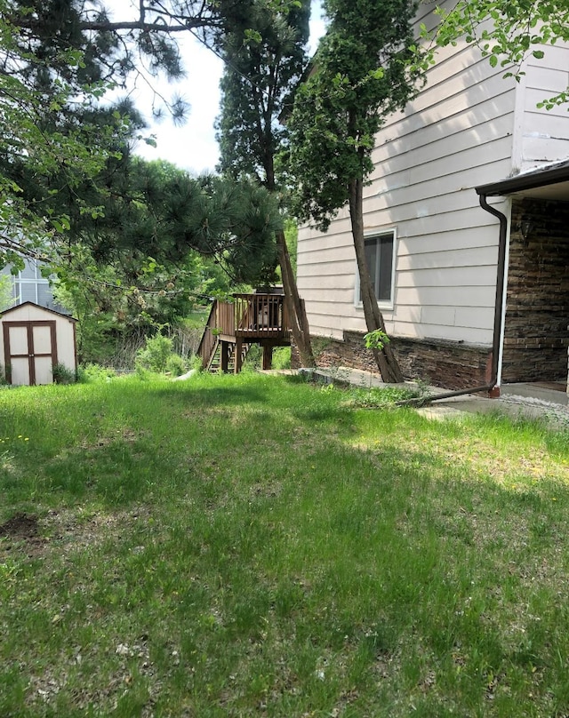 10989 Osage St NW, Coon Rapids, MN 55433 - view of yard with a shed, an outdoor structure, and a deck