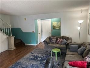 10989 Osage St NW, Coon Rapids, MN 55433 - living room featuring wood finished floors, stairway, and baseboards