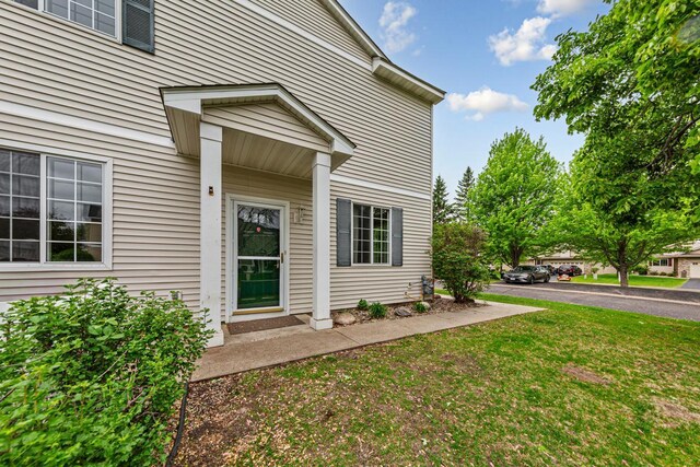 13037 Europa Trail Way N Unit A, Hugo, MN 55038 - doorway to property with a lawn