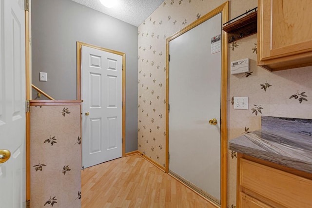 13037 Europa Trail Way N Unit A, Hugo, MN 55038 - bathroom with wallpapered walls, wood finished floors, a textured ceiling, and baseboards