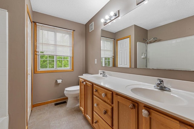 13037 Europa Trail Way N Unit A, Hugo, MN 55038 - full bath with a shower, toilet, a textured ceiling, double vanity, and tile patterned flooring