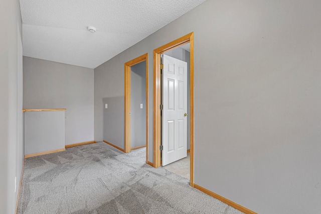 13037 Europa Trail Way N Unit A, Hugo, MN 55038 - carpeted spare room with baseboards, a smoke detector, and a textured ceiling