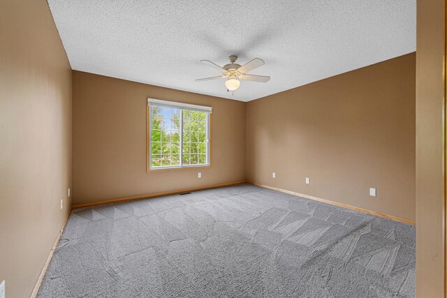 13037 Europa Trail Way N Unit A, Hugo, MN 55038 - empty room with a ceiling fan, carpet floors, baseboards, and a textured ceiling