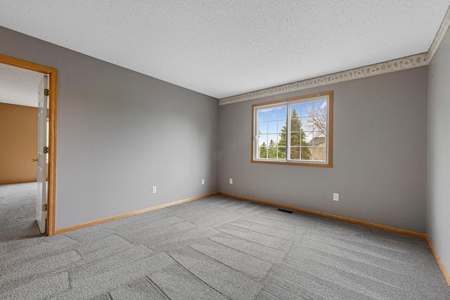 13037 Europa Trail Way N Unit A, Hugo, MN 55038 - spare room featuring a textured ceiling, carpet floors, and baseboards
