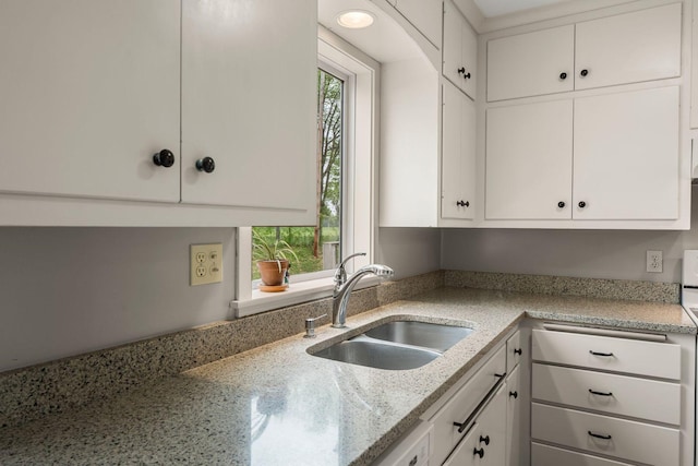 2401 Decatur Ave S, Saint Louis Park, MN 55426 - kitchen with a sink, white cabinets, and light stone countertops