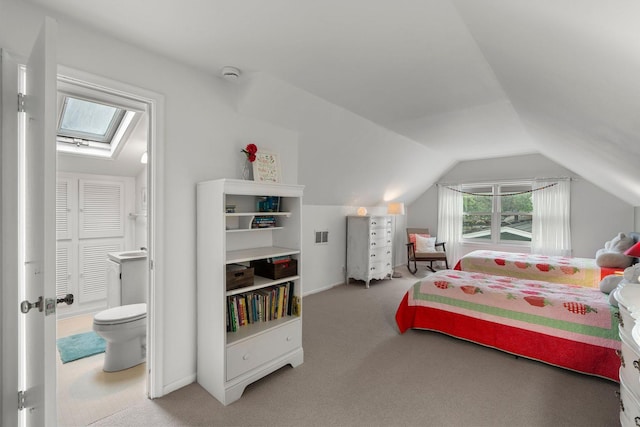 2401 Decatur Ave S, Saint Louis Park, MN 55426 - bedroom with a skylight, lofted ceiling, connected bathroom, and carpet floors