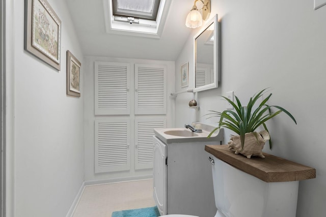 2401 Decatur Ave S, Saint Louis Park, MN 55426 - bathroom with a skylight, vanity, toilet, and baseboards