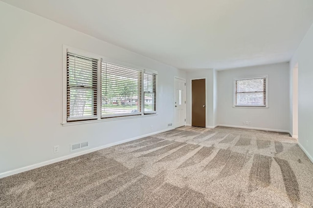 11131 Magnolia St NW, Coon Rapids, MN 55448 - unfurnished room featuring light colored carpet, plenty of natural light, and baseboards