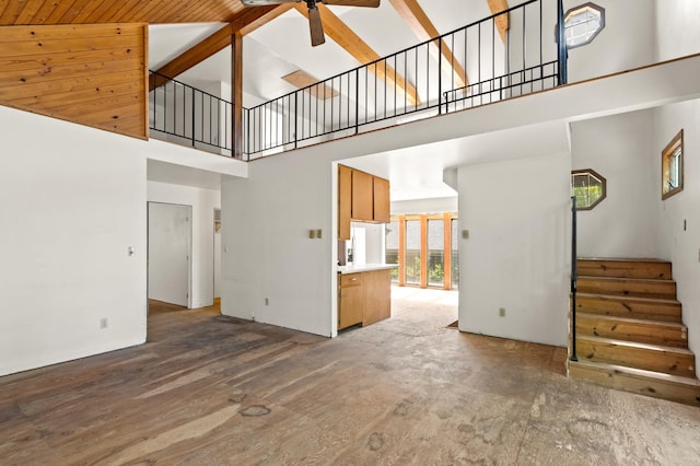 13144 Maple Circle Dr SE, Hudson Twp, MN 56334 - unfurnished living room with high vaulted ceiling, ceiling fan, stairs, and wood finished floors