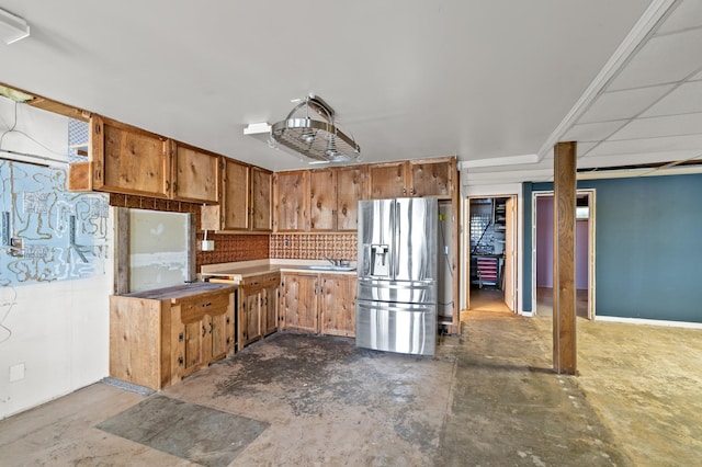 13144 Maple Circle Dr SE, Hudson Twp, MN 56334 - kitchen featuring stainless steel fridge, concrete flooring, brown cabinets, and a sink