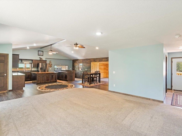 1465 State 84 NW, Backus, MN 56435 - carpeted living area with lofted ceiling, a ceiling fan, baseboards, and a textured ceiling