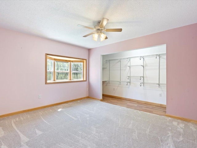 1465 State 84 NW, Backus, MN 56435 - unfurnished bedroom with carpet floors, baseboards, a closet, a textured ceiling, and ceiling fan