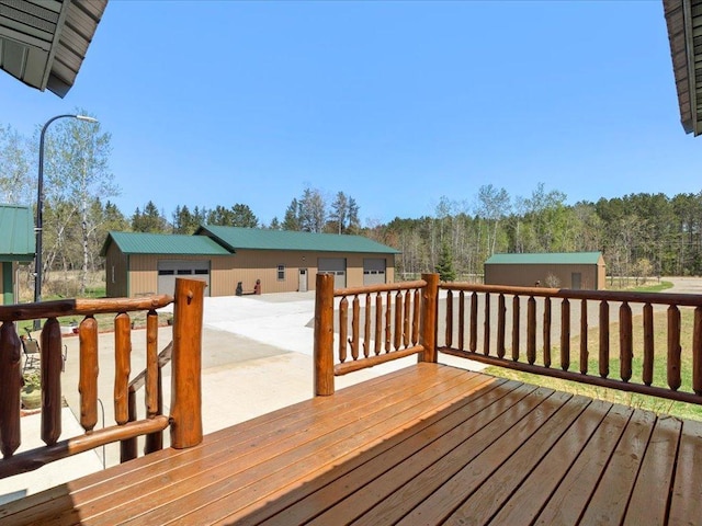 1465 State 84 NW, Backus, MN 56435 - deck featuring an outbuilding, a forest view, and a detached garage