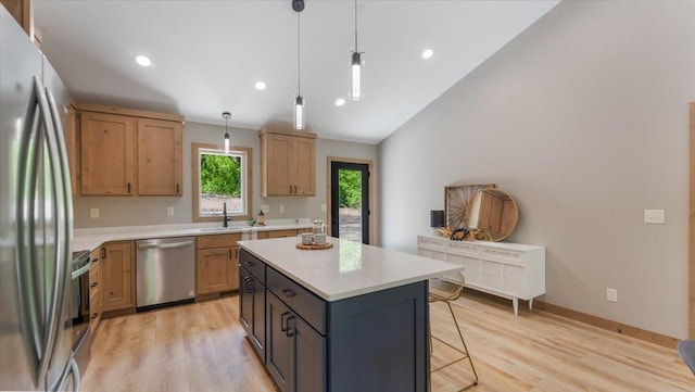 2948 N Oaks Ln NW, Garfield, MN 56332 - kitchen with stainless steel appliances, light countertops, a breakfast bar, a sink, and light wood-type flooring