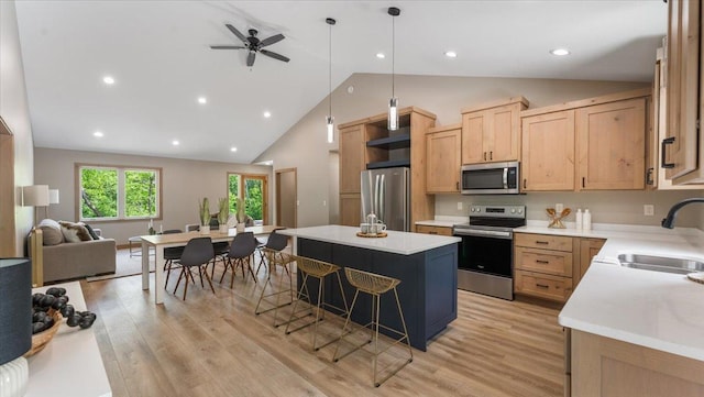 2948 N Oaks Ln NW, Garfield, MN 56332 - kitchen featuring appliances with stainless steel finishes, a sink, light brown cabinetry, a center island, and high vaulted ceiling