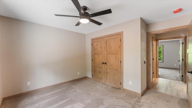 2948 N Oaks Ln NW, Garfield, MN 56332 - unfurnished bedroom with light colored carpet, baseboards, a closet, and a ceiling fan