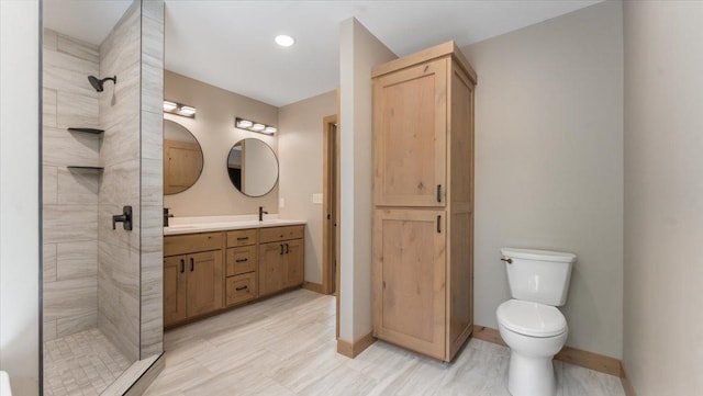 2948 N Oaks Ln NW, Garfield, MN 56332 - full bathroom featuring double vanity, a stall shower, baseboards, toilet, and recessed lighting