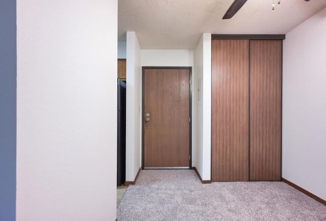 221 Grand Ave W Unit 314, South Saint Paul, MN 55075 - unfurnished bedroom with baseboards, light colored carpet, a textured ceiling, a closet, and freestanding refrigerator