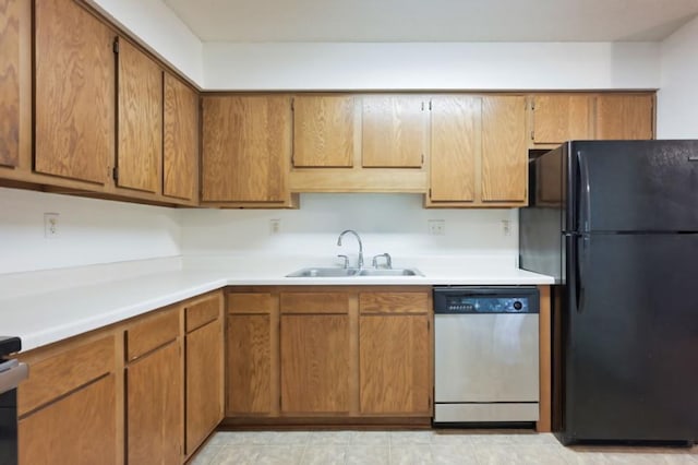 221 Grand Ave W Unit 314, South Saint Paul, MN 55075 - kitchen featuring stainless steel dishwasher, freestanding refrigerator, a sink, light countertops, and brown cabinets