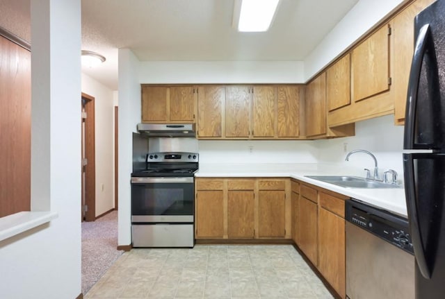 221 Grand Ave W Unit 314, South Saint Paul, MN 55075 - kitchen featuring stainless steel appliances, under cabinet range hood, a sink, light countertops, and brown cabinetry