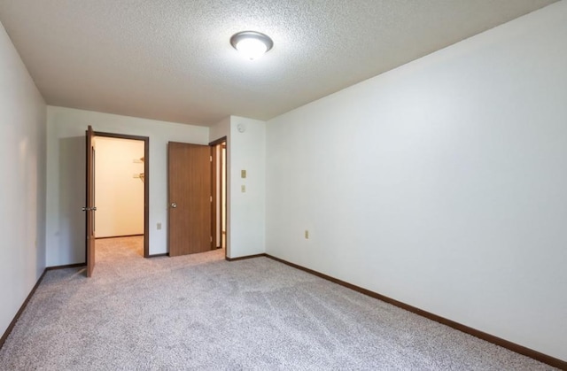 221 Grand Ave W Unit 314, South Saint Paul, MN 55075 - unfurnished bedroom with a textured ceiling, light colored carpet, and baseboards