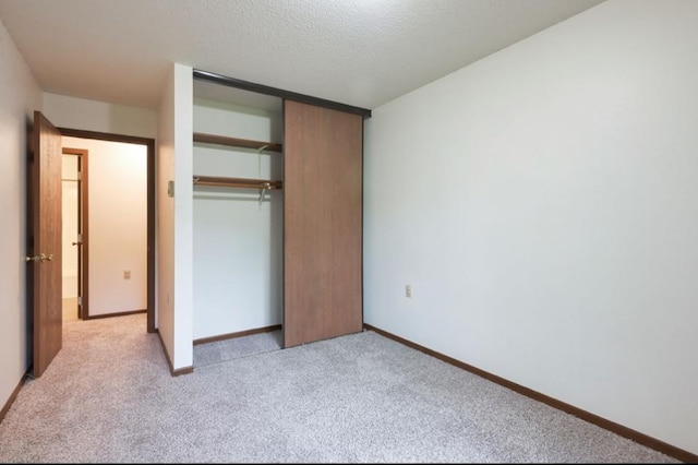 221 Grand Ave W Unit 314, South Saint Paul, MN 55075 - unfurnished bedroom featuring light colored carpet, a closet, baseboards, and a textured ceiling