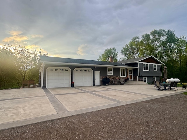 11946 180th St, Milaca Twp, MN 56353 - view of front of home with an attached garage, driveway, and a chimney