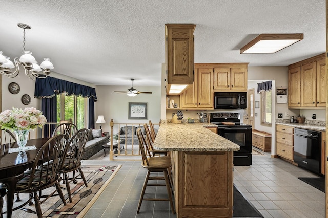11946 180th St, Milaca Twp, MN 56353 - kitchen featuring black appliances, a peninsula, a kitchen bar, a chandelier, and a textured ceiling