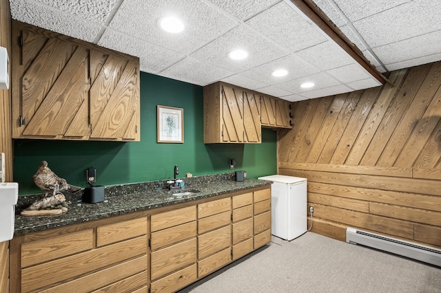 11946 180th St, Milaca Twp, MN 56353 - laundry area with a baseboard radiator, a sink, light colored carpet, wooden walls, and recessed lighting