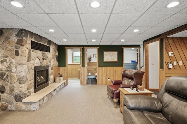 11946 180th St, Milaca Twp, MN 56353 - living room with wooden walls, carpet flooring, a wainscoted wall, a fireplace, and a drop ceiling