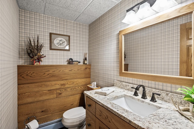 11946 180th St, Milaca Twp, MN 56353 - bathroom featuring toilet, wallpapered walls, vanity, and baseboard heating