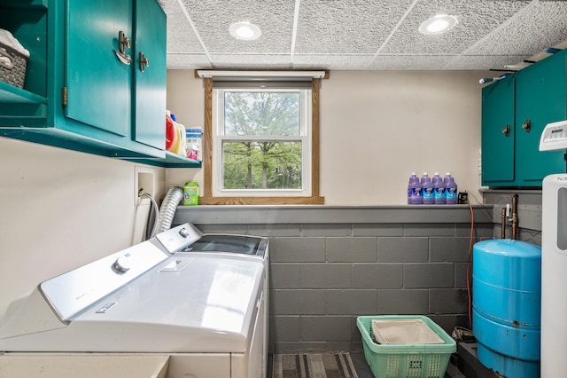 11946 180th St, Milaca Twp, MN 56353 - washroom with separate washer and dryer, cabinet space, concrete block wall, and recessed lighting