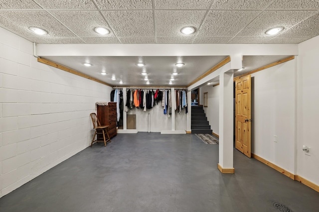 11946 180th St, Milaca Twp, MN 56353 - finished basement featuring concrete block wall, stairs, and baseboards