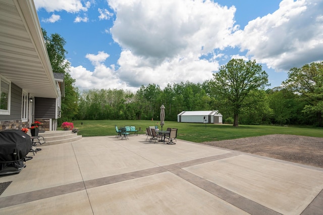 11946 180th St, Milaca Twp, MN 56353 - view of patio / terrace featuring grilling area, outdoor dining space, and an outdoor structure