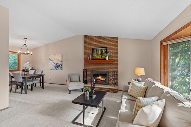 3225 Hillsboro Ave N, New Hope, MN 55427 - living room with vaulted ceiling, a chandelier, a fireplace, and carpet flooring