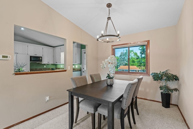 3225 Hillsboro Ave N, New Hope, MN 55427 - dining area with a chandelier, light colored carpet, and vaulted ceiling