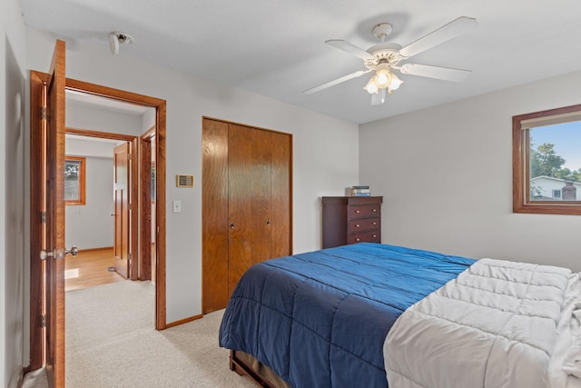 3225 Hillsboro Ave N, New Hope, MN 55427 - bedroom featuring light colored carpet, a closet, and ceiling fan