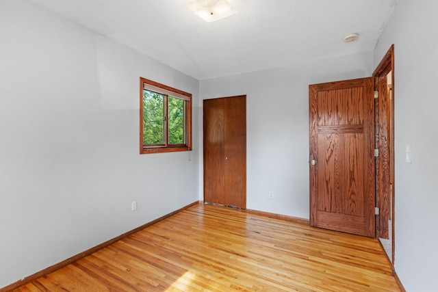 3225 Hillsboro Ave N, New Hope, MN 55427 - unfurnished bedroom with light wood-style flooring and baseboards