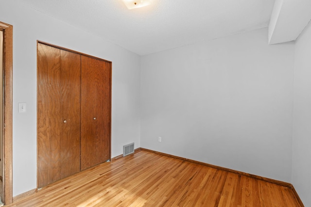 3225 Hillsboro Ave N, New Hope, MN 55427 - unfurnished bedroom with a closet and light wood-style floors