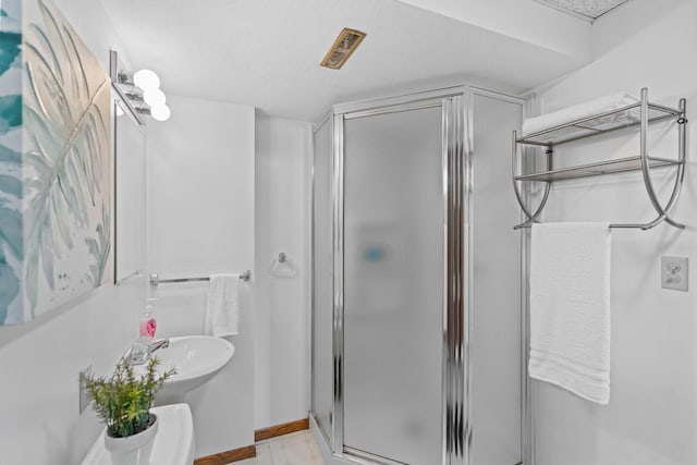 3225 Hillsboro Ave N, New Hope, MN 55427 - bathroom featuring a stall shower and a textured ceiling